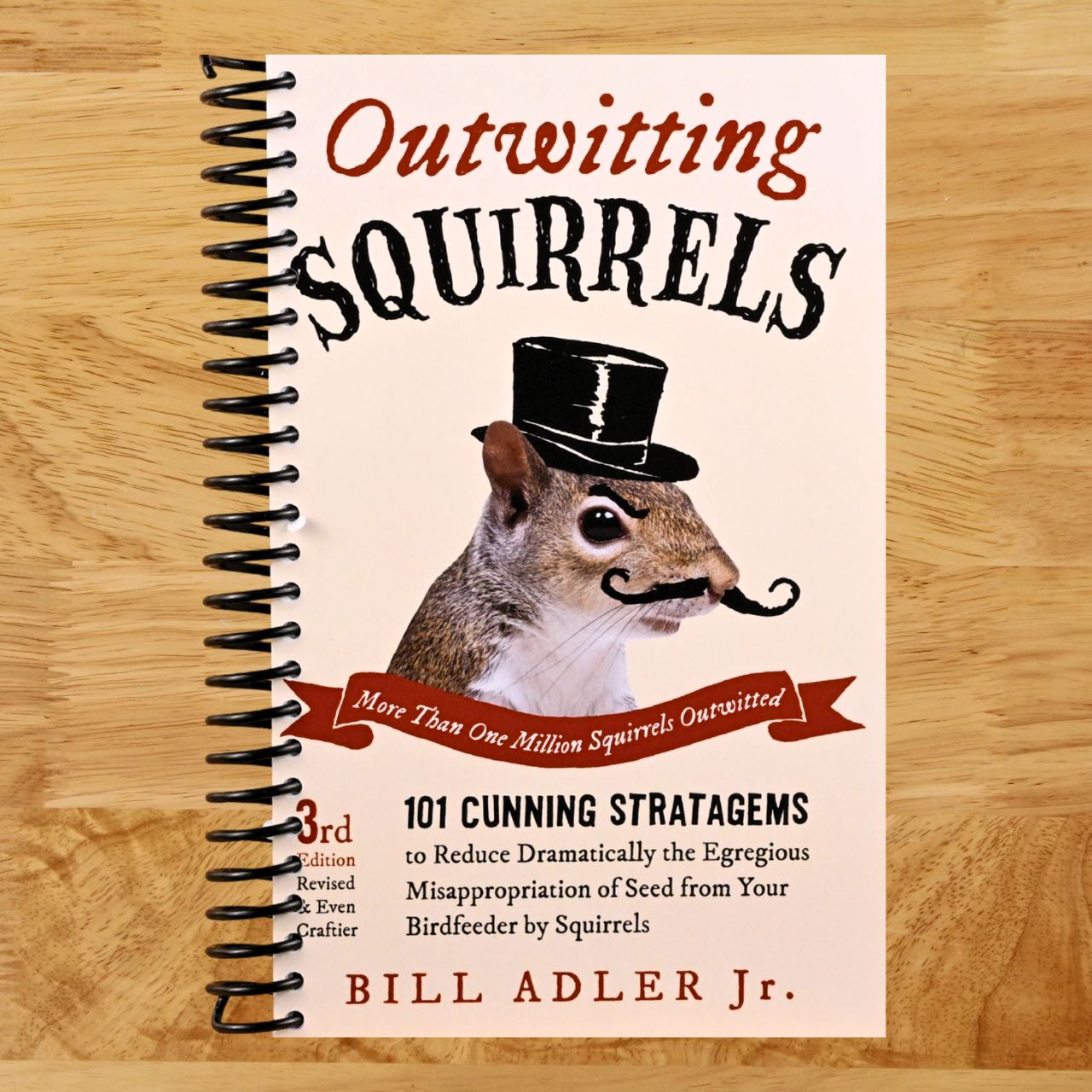 Outwitting Squirrels: 101 Cunning Stratagems to Reduce Dramatically the Egregious Misappropriation of Seed from Your Birdfeeder by Squirrels (Spiral bound) Happy Coil spiral bound book